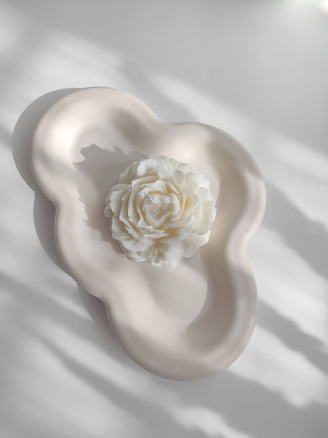 plateau déco en forme de nuage. déco minimaliste pour salon. plateau artisanale avec une bougie sculpturale pivoine.